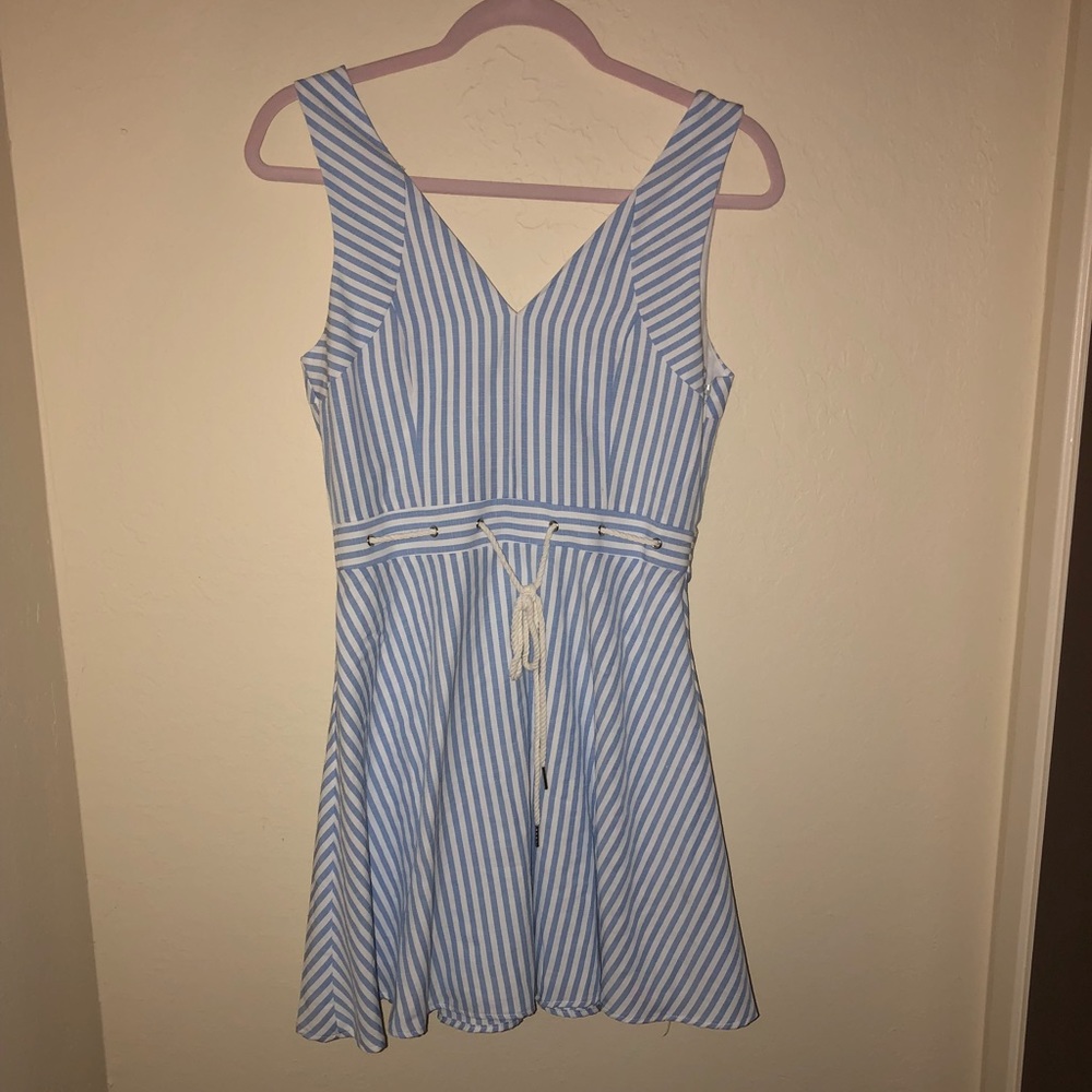 Blue and white stripped-dress with a tie on it